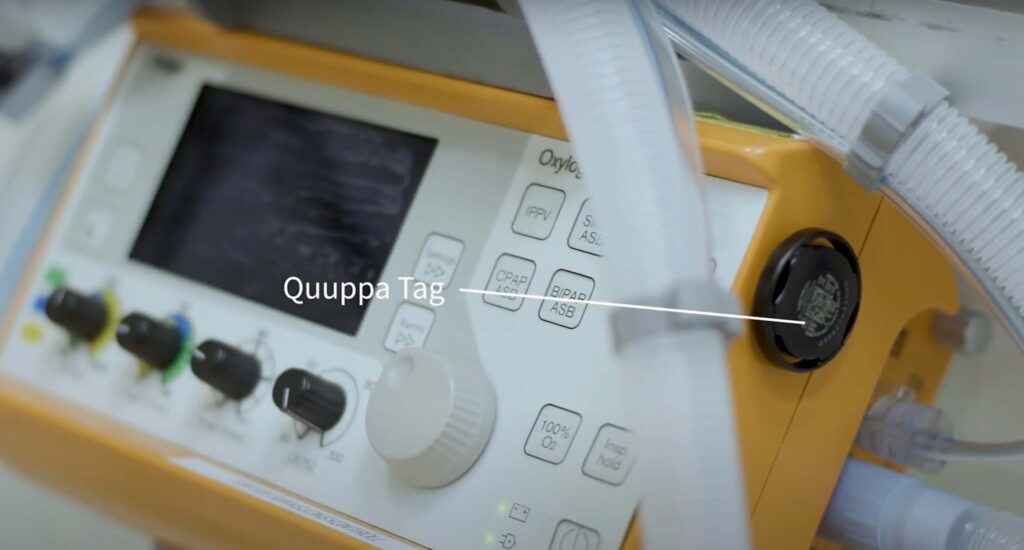 Quuppa asset tracking tag attached to hospital equipment.